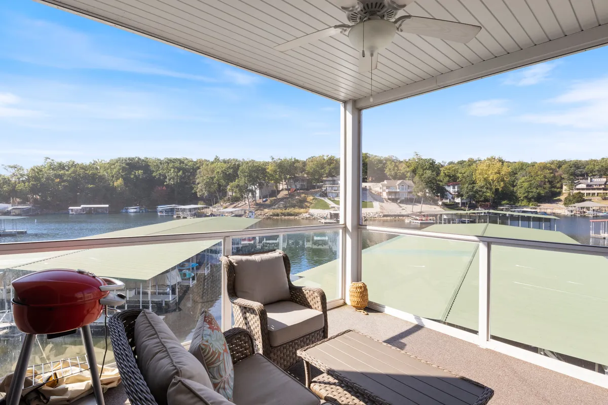An outdoor seating area with a grill and a beautiful lake view sets the scene for al fresco dining and relaxed gatherings. The space seamlessly connects indoor meal preparation with outdoor enjoyment.
